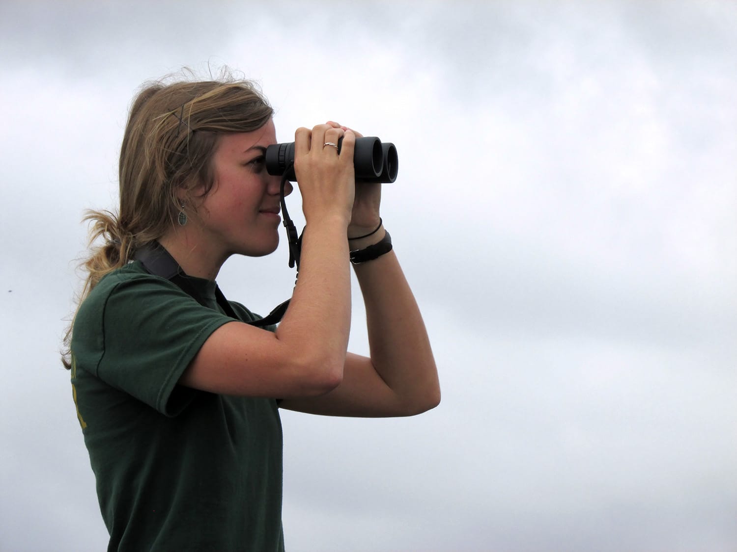 Emily Kimmel keeps her eyes on the skies during a previous Hawk Watch at Grandfather Mountain. Binoculars and cameras aid in viewing the migrating raptors, but most birds are visible with the naked eye. Photo courtesy of the Grandfather Mountain Stewardship Foundation