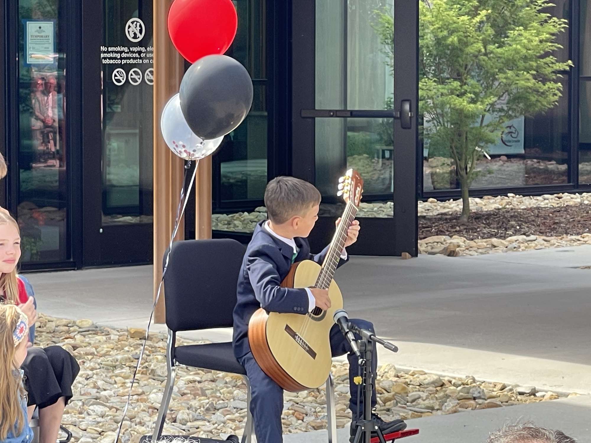 A Valle Crucis student performs a guitar solo at the dedication ceremony.