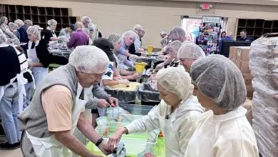 Volunteers in hairnets pack meals at long tables at First Baptist Church of Newland during the Hope for the High Country event on June 20, 2026, benefiting Avery County families recovering from Hurricane Helene.