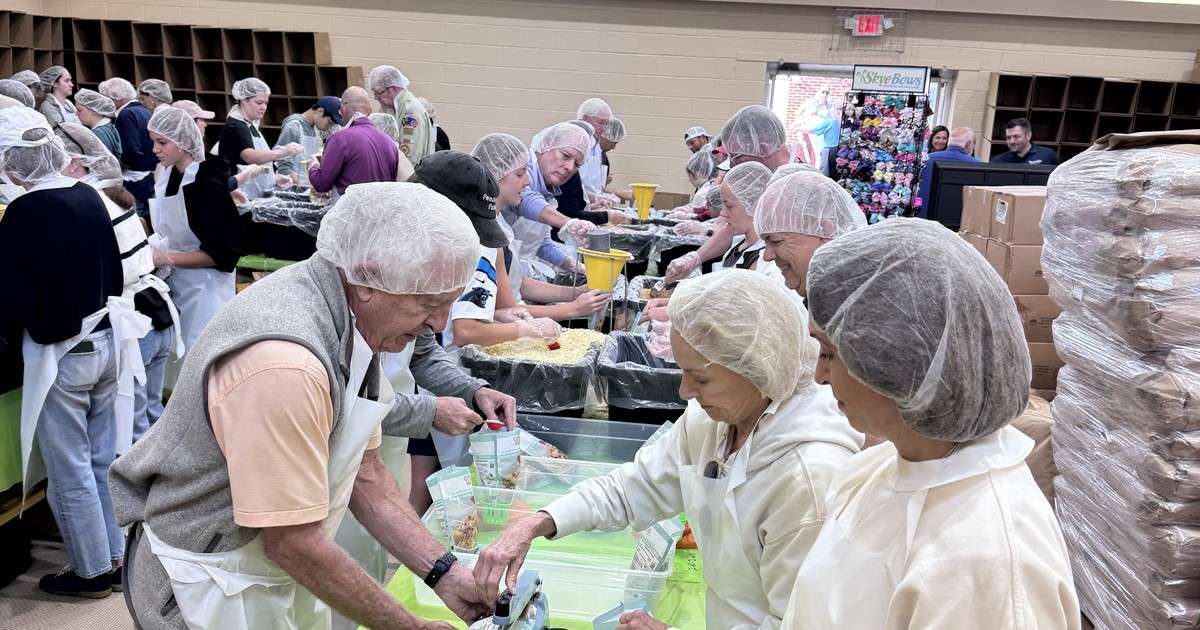 Volunteers in hairnets pack meals at long tables at First Baptist Church of Newland during the Hope for the High Country event on June 20, 2026, benefiting Avery County families recovering from Hurricane Helene.