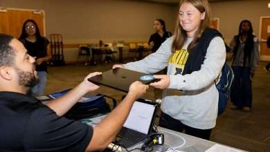 An E2D representative hands a new laptop to a first-year App State student during the Aug. 27 distribution event in Plemmons Student Union. Photo by Kyla Willoughby