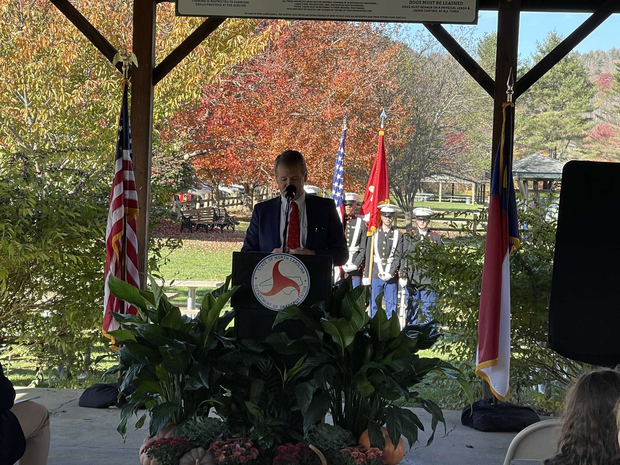 Speaker at podium with Junior ROTC color guard