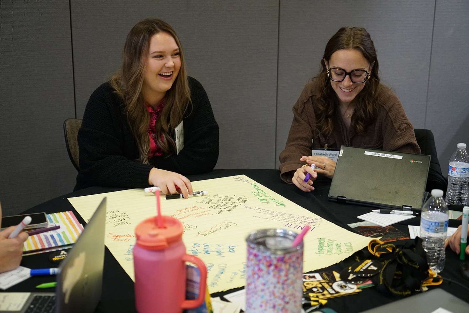Two teachers work on a brainstorming activity at an ETL workshop at App State