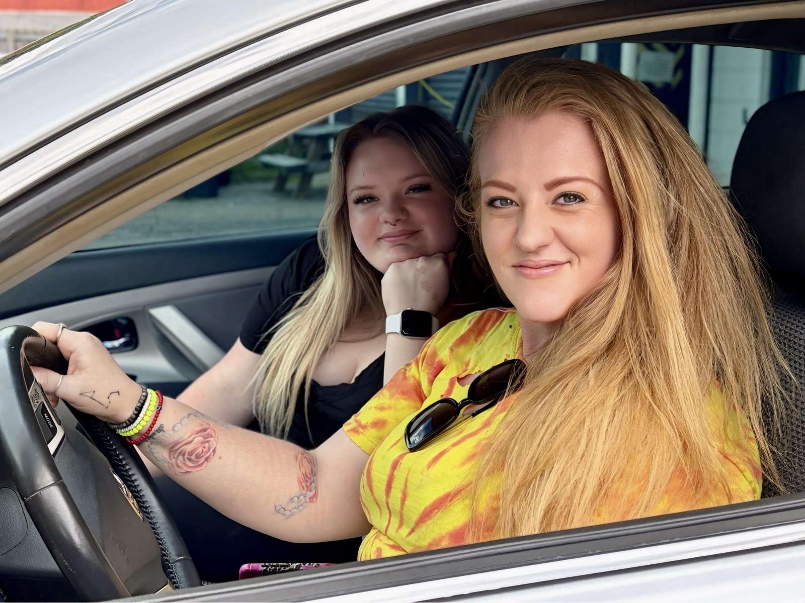 Two women seated in a car provided through the Working Wheels Helene Replacement Car Program